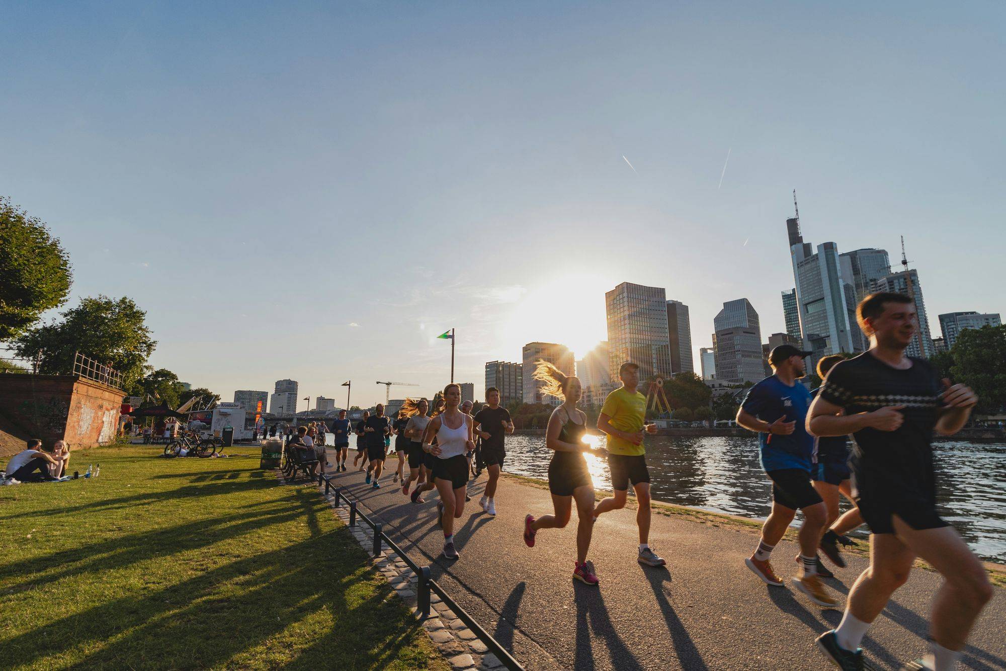 A group of runners on an evening run along a river